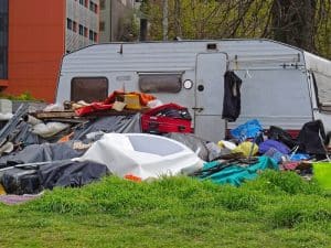 Piles of rubbish and a caravan show the reality of types of hoarding.