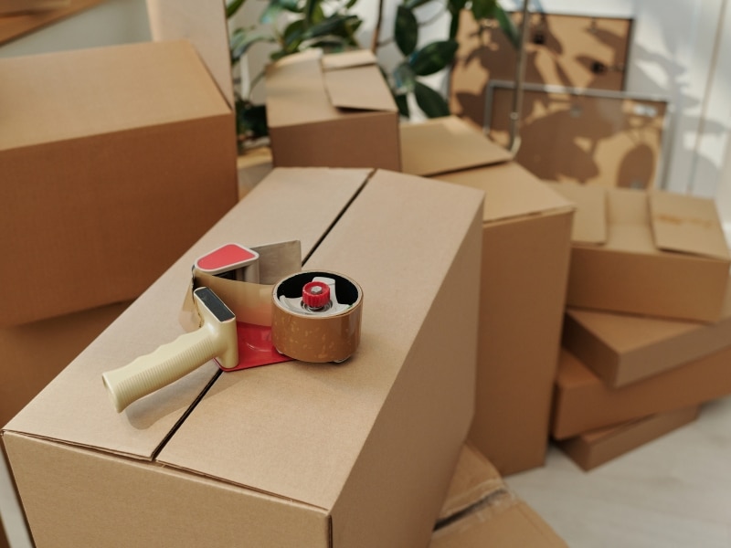 Boxes being sealed, representing the concept of deceased house clearance.